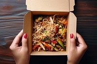 Takeaway food box meal hand vegetable.