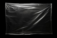  Plastic wrap black bag black background. AI generated Image by rawpixel.