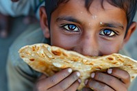 Indian boy eating food biting freshness.