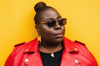 Cool chubby young black woman with fashionable clothing style full body on colored background sunglasses necklace portrait.