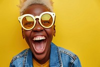 Cool chubby young black woman with fashionable clothing style full body on colored background sunglasses laughing fun.