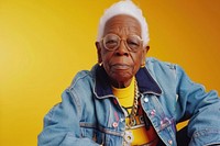 Cool senior black woman with fashionable clothing style portrait on colored background glasses adult male.