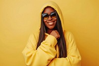Cool young black woman with fashionable clothing style full body on colored background smile fun sunglasses.