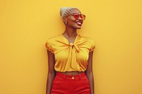 Cool young black woman with fashionable clothing style full body on colored background smile individuality sunglasses.