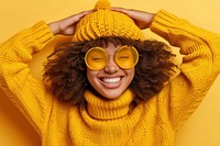 Cool young black woman with fashionable clothing style full body on colored background laughing sweater smile.