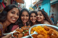 Indian girls eating food smiling adult.