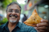 Indian uncle eating food smiling adult.