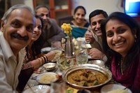 Indian family dinner food smiling adult.