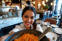 Indian hotel waitress serving smiling adult food.