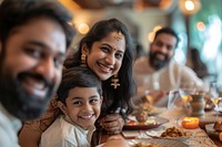 Indian family eating restaurant smiling candle.