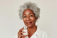 Multiracial senior woman holding a skincare bottle portrait photo photography.