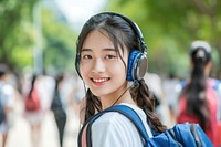 Chinese student listening music headphones headset school.