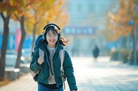 Korean student listening music walking headphones adult.