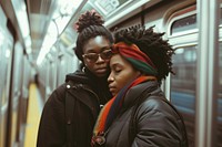 African American lgbtq couple standing as they travel on subway adult togetherness affectionate.