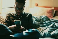 African American young man bedroom adult mobile phone.