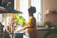 African American young woman kitchen plant architecture.