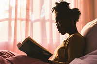 African American young woman reading bedroom adult.