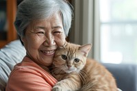 East asia old women kitten portrait smiling.