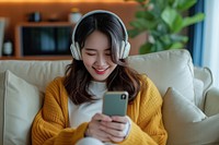 East asian female headphones listening sitting.