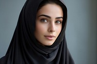 Middle eastern teen woman in abaya and hijab portrait looking photo.