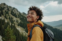 Mixed race teen man backpack mountain outdoors.