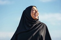 Plus size Middle eastern woman outdoors laughing adult.