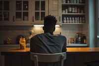 African American young man sitting kitchen black.