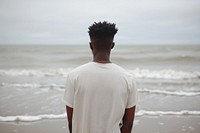 African American young man beach standing outdoors.