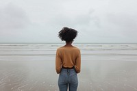 African American young woman standing outdoors horizon.