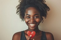 Smiling black woman holding adult smile.
