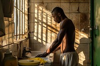 Black South African man bathroom cleaning adult.