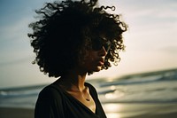 A cool black teenage girl at the beach photography portrait motion. 