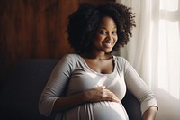 Black pregnant woman smiling sitting adult. 