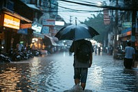 Man holding umbrella and walking while raining vehicle flood adult. 