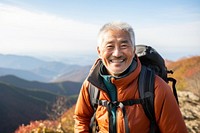Happy senior japanese man hiking recreation adventure.