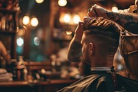 Barber doing haircut for his customer barbershop adult hairdresser. 