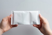 Doypack Packaging  holding white paper.