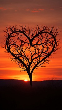  Heart-shaped tree silhouette formed nature outdoors sunset. AI generated Image by rawpixel.