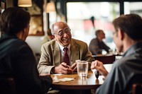 Senior gentleman engaged in a lively conversation with friends at a local cafe restaurant adult togetherness. AI generated Image by rawpixel.