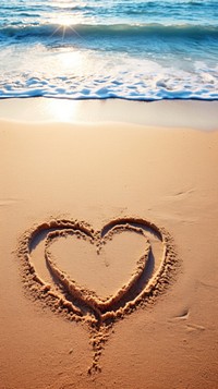  The word love written in sand on the beach outdoors nature ocean. 