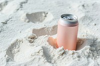 Drink can partially buried in white sand refreshment container bottle.