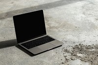 Black laptop on concrete floor computer screen portability.