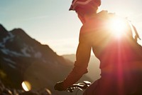Cyclist riding up in high mountains sunlight outdoors nature.