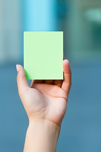 Green pastel Sticky note  hand holding finger.