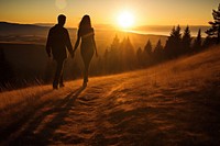 Tourists holding hand on the hill in the sunrise outdoors walking adult.