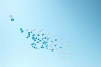 Medicine pills drops on table with blue background backgrounds outdoors balloon. AI generated Image by rawpixel.