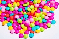 Multi-colored pills scattered on a bright background confectionery backgrounds candy. AI generated Image by rawpixel.