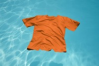 Orange t-shirt floating in pool