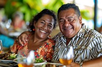 Samoan couple restaurant laughing dinner.