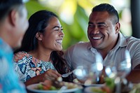 Samoan couple restaurant laughing romantic.